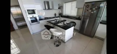 Modern kitchen with sleek appliances and stylish island seating
