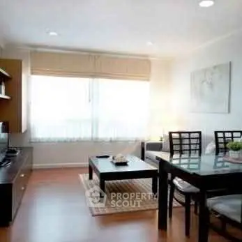 Bright and inviting living room with modern furniture and large window.