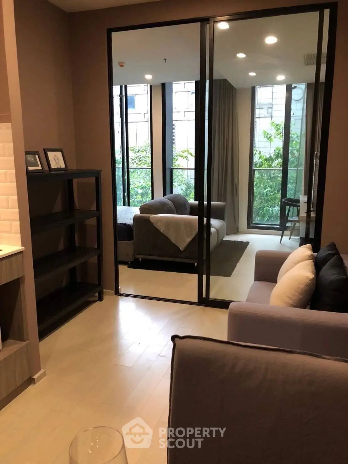 Modern living room with glass doors and cozy seating area