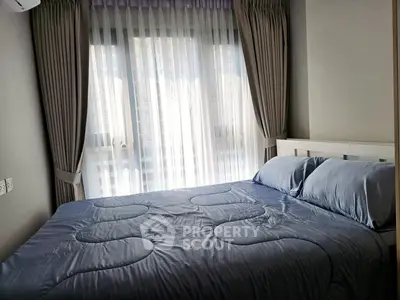 Cozy bedroom with large window and elegant curtains in modern apartment