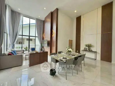 Luxurious living room with high ceilings and elegant dining area