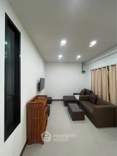 Modern living room with sleek furniture and neutral tones