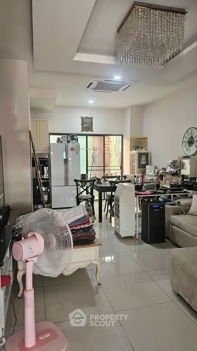 Spacious living room with modern decor and large windows for natural light.