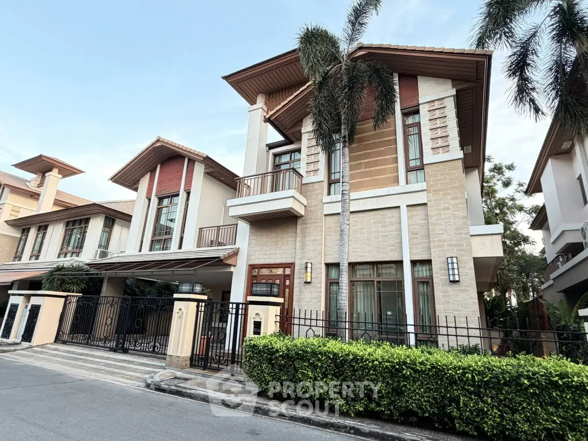 Luxurious modern house with elegant facade and lush greenery in upscale neighborhood.