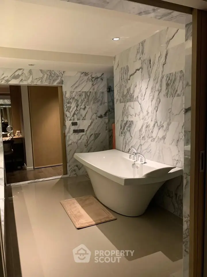 Luxurious marble bathroom with elegant freestanding bathtub and modern design.