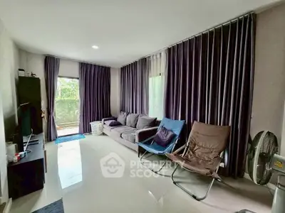 Spacious living room with modern decor and large windows for natural light.
