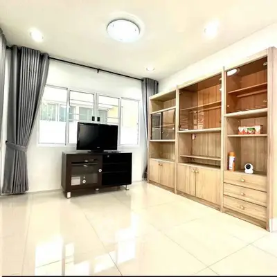 Bright living room with modern furniture and large windows in a stylish apartment.