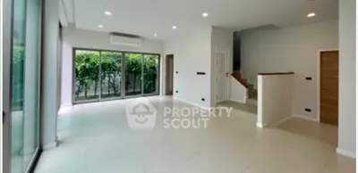 Spacious modern living room with large windows and garden view