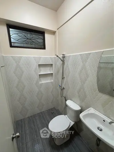 Modern bathroom with sleek tile design and compact fixtures