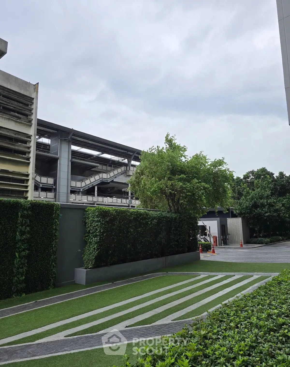 Modern building exterior with lush greenery and sleek architectural design