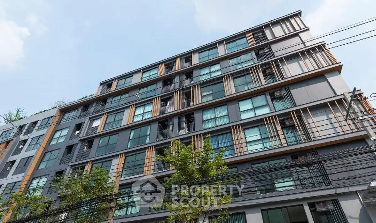 Modern urban apartment building with sleek design and large windows.