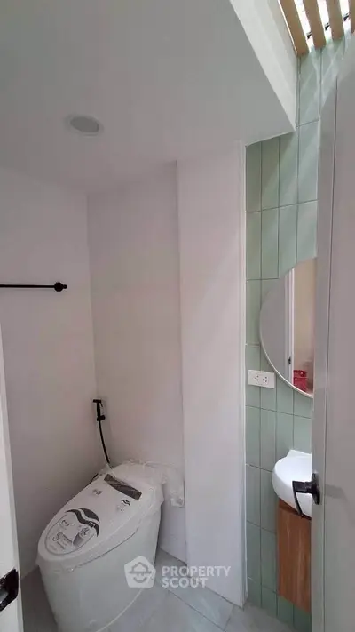 Modern bathroom with sleek toilet and stylish sink in compact space