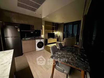 Modern open-layout kitchen and living room with city view, featuring sleek appliances and stylish decor.