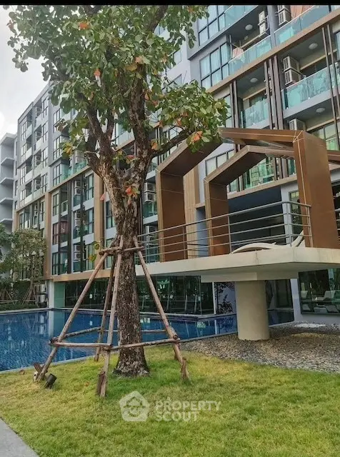 Modern condominium with pool and landscaped garden view