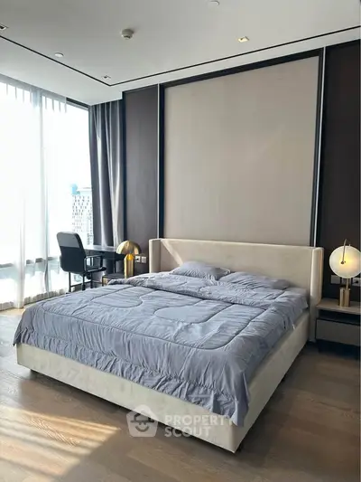 Luxurious bedroom with modern decor and large windows offering natural light.