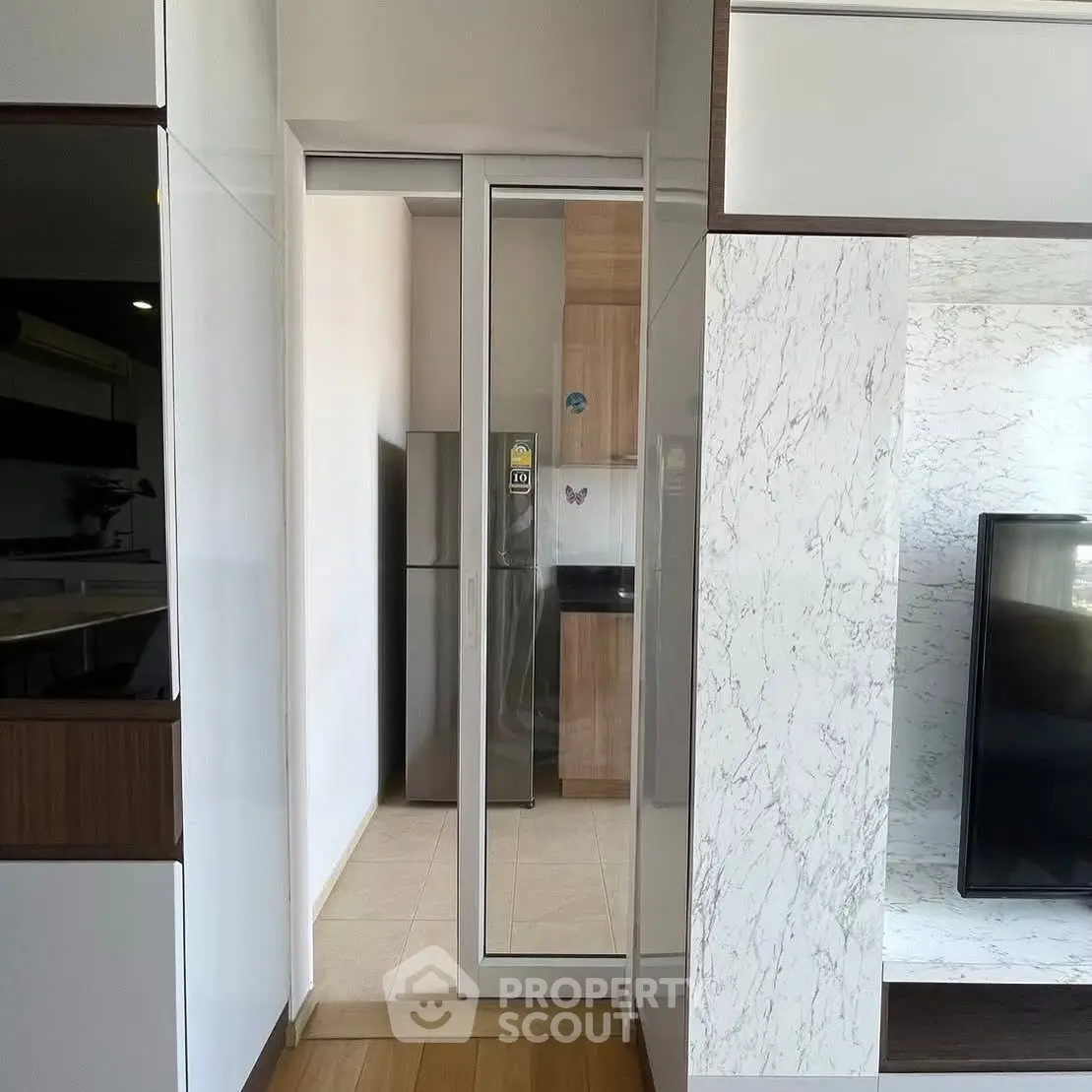 Modern kitchen with sleek design and stainless steel appliances in a stylish apartment.