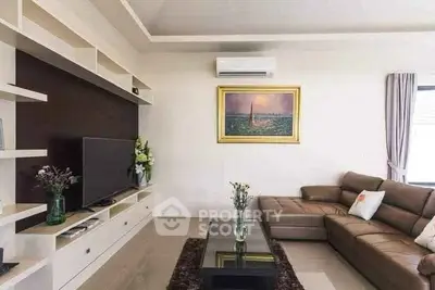 Modern living room with sleek furniture and wall-mounted TV, perfect for relaxation.