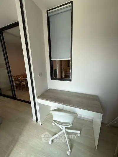 Modern study nook with sleek desk and chair in a contemporary apartment.