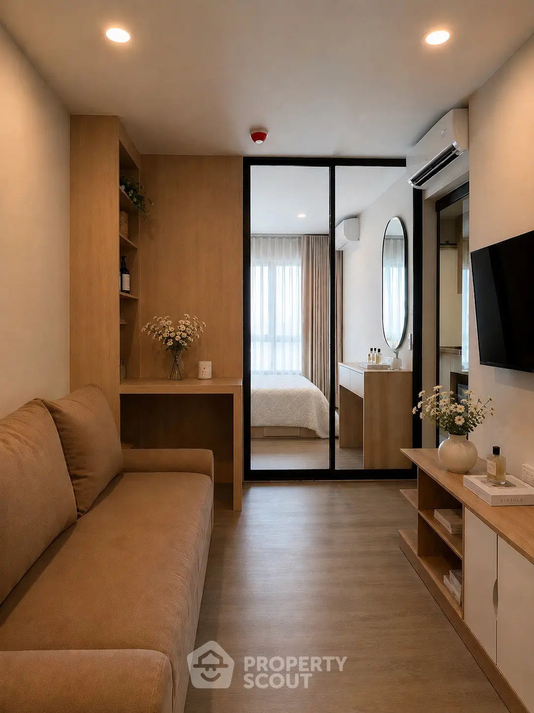 Modern apartment interior with cozy living room and view into stylish bedroom