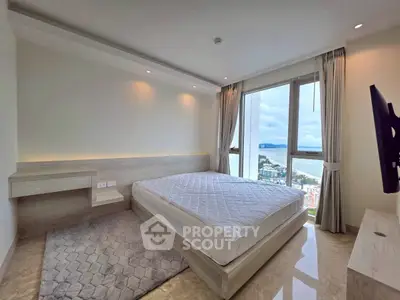 Luxurious bedroom with stunning city and ocean view, featuring modern decor and large windows for natural light.