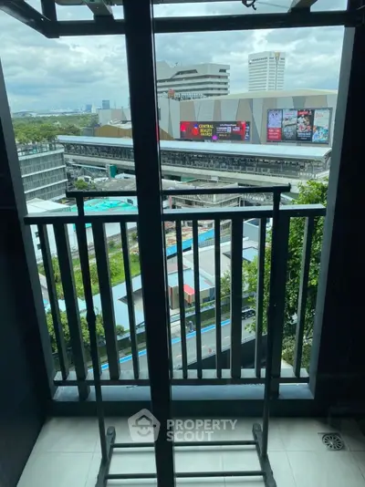 Modern balcony with city view overlooking shopping mall and skyline