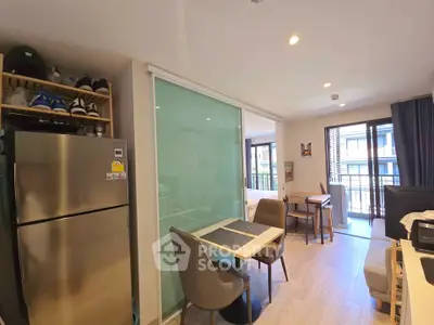 Modern open-plan living area with dining space and balcony access