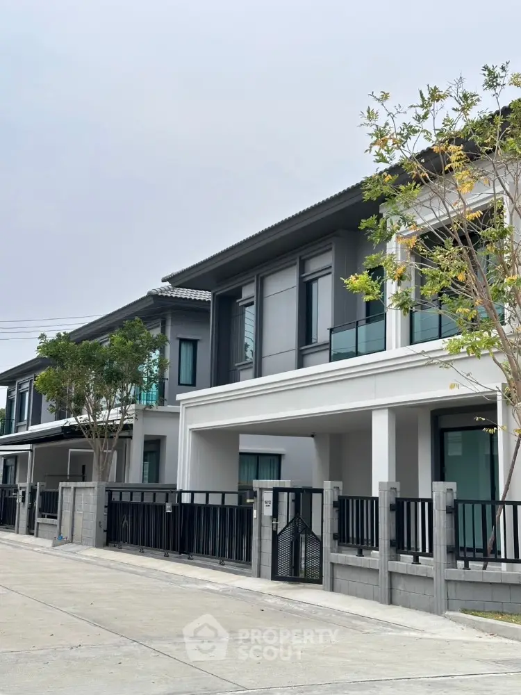 Modern two-story townhouse with sleek design and spacious balconies in a serene neighborhood.
