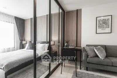 Modern bedroom with glass partition, cozy sofa, and stylish decor in a contemporary apartment.
