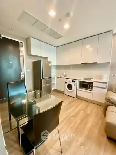 Modern kitchen with sleek appliances and dining area in a stylish apartment
