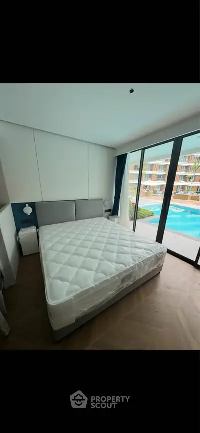 Spacious bedroom with pool view and modern design