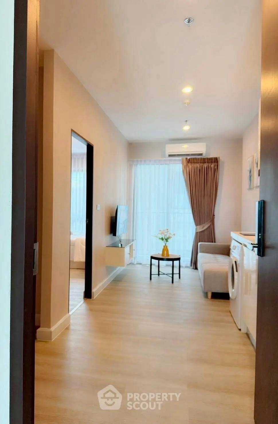 Modern living room with washing machine and stylish decor in a bright apartment