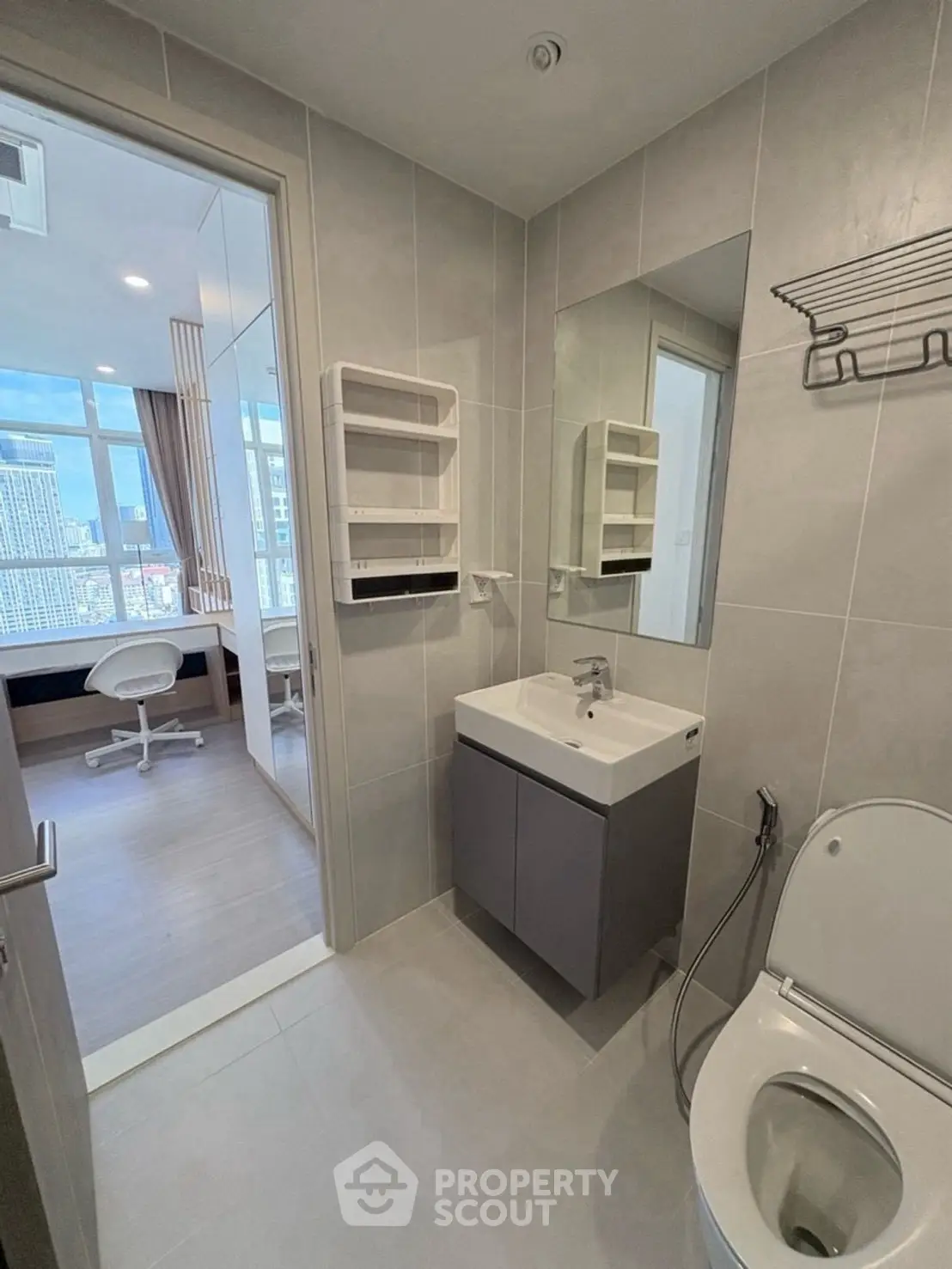 Modern bathroom with sleek fixtures and city view from adjacent room