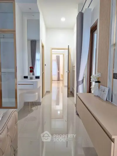 Elegant hallway with modern decor and glossy tiles in a luxurious home interior.