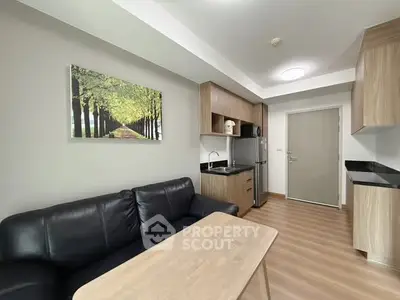 Modern living room with sleek kitchen and cozy black sofa
