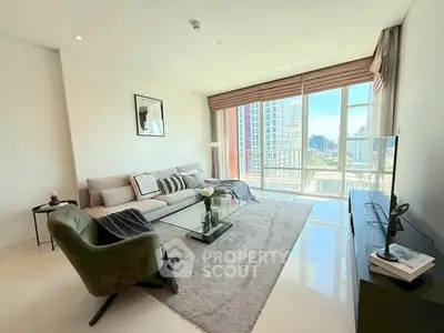 Spacious modern living room with large windows and city view, featuring stylish furniture and decor.