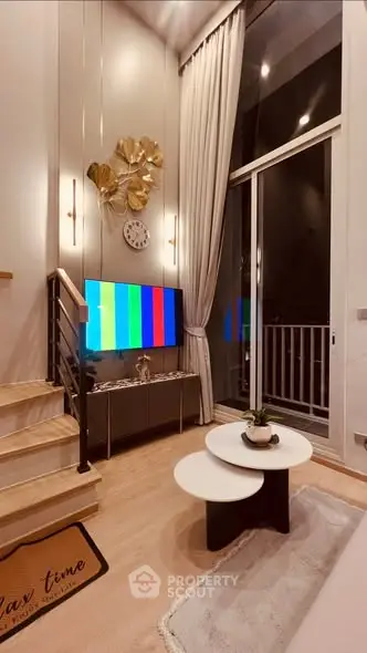 Modern living room with high ceilings, stylish decor, and large windows for natural light.