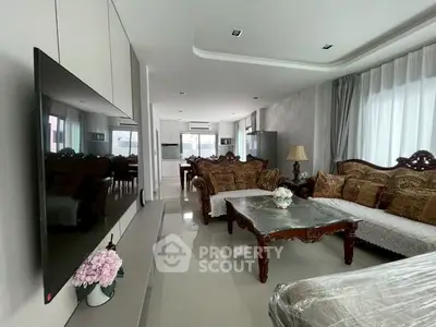 Luxurious living room with elegant furniture and modern TV setup