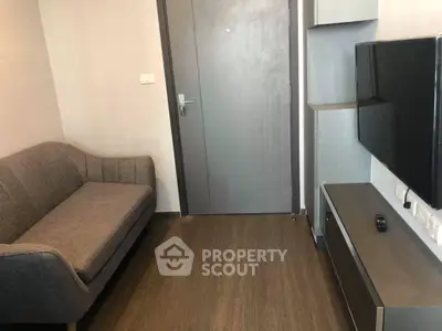 Modern living room with sleek furniture and flat-screen TV, perfect for urban living.