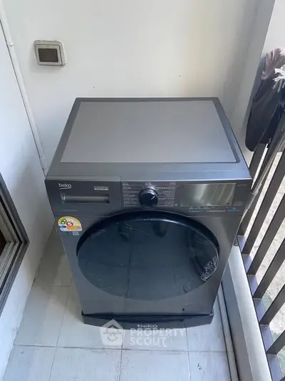 Modern washing machine on a balcony in a residential property.