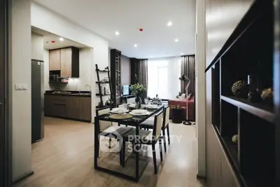 Modern open-plan living and dining area with stylish kitchen and cozy seating.