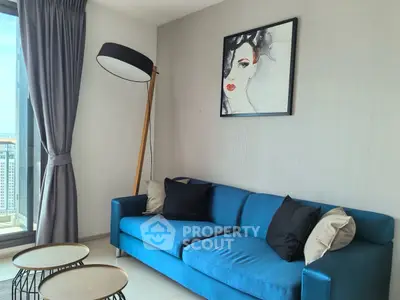 Stylish living room with blue sofa and modern decor, perfect for urban living.