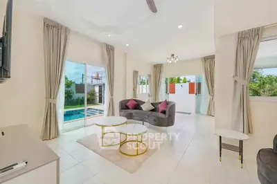 Spacious living room with pool view and elegant decor