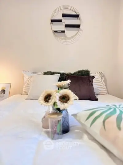 Cozy bedroom with stylish decor and plush pillows, perfect for relaxation.