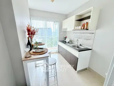 Modern kitchen with open layout and city view, featuring sleek cabinetry and natural light.