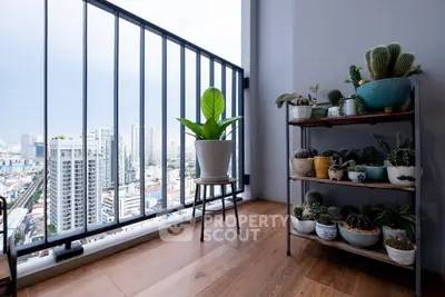Chic urban balcony with stunning city view and stylish plant decor.