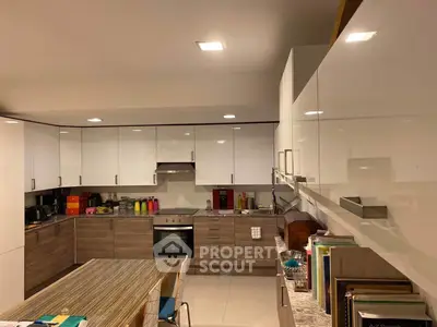 Modern kitchen with sleek cabinetry and built-in oven, perfect for culinary enthusiasts.