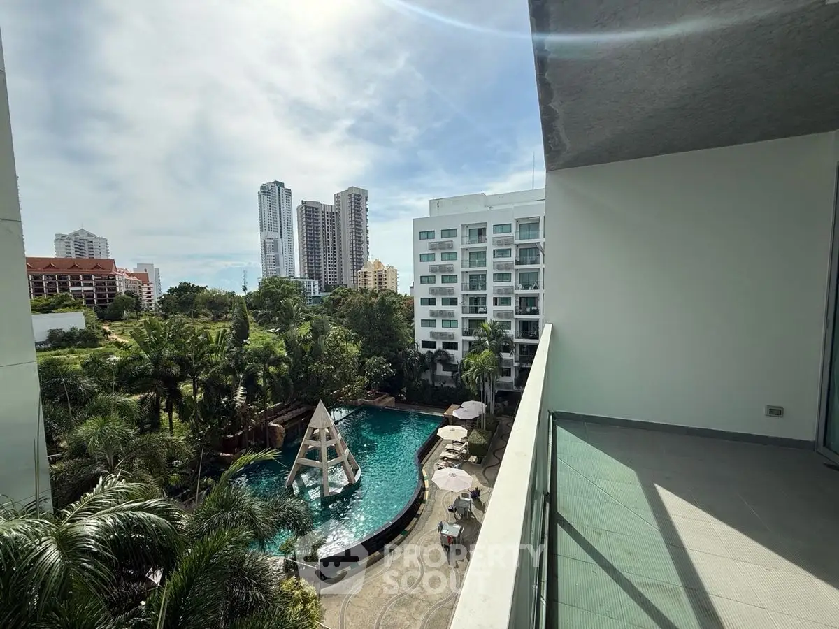 Luxurious balcony view overlooking pool and city skyline, perfect for urban living.