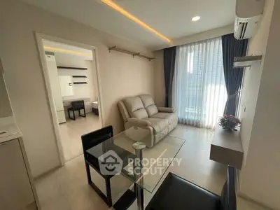Modern living room with sleek furniture and large window in a stylish apartment