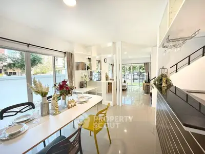 Modern open-plan kitchen and dining area with sleek design and abundant natural light.