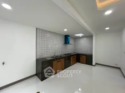 Modern kitchen with sleek design and gas stove in a spacious layout